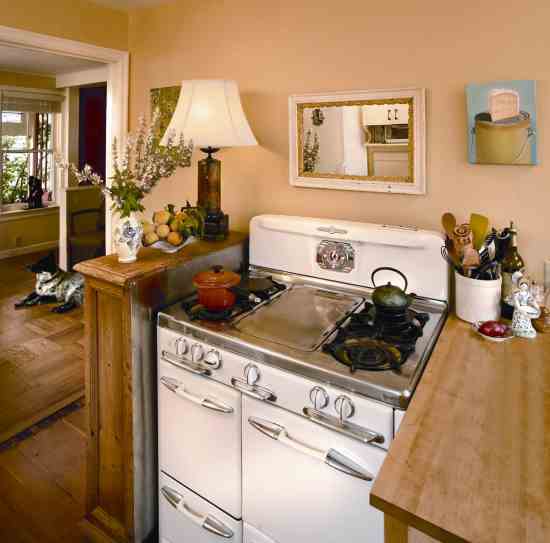 The kitchen opens into the living room, where Alma’s dog and constant companion, Sabu, keeps watch over her front door.
